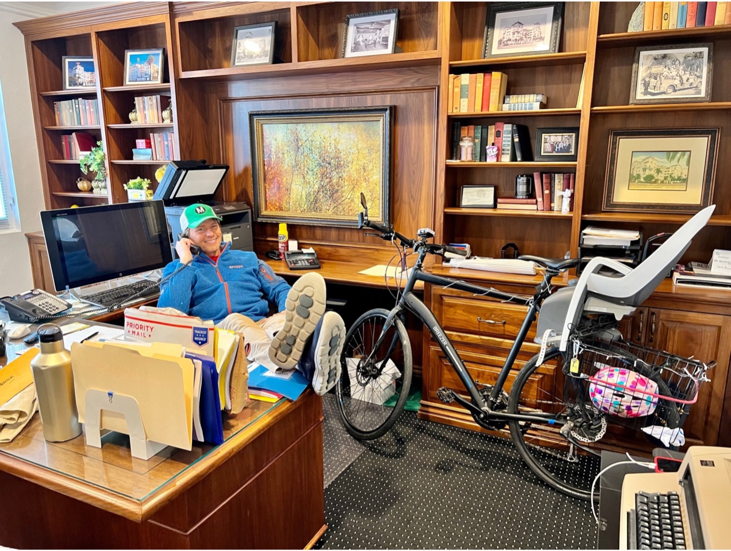 Chris Balish in his office with his bike