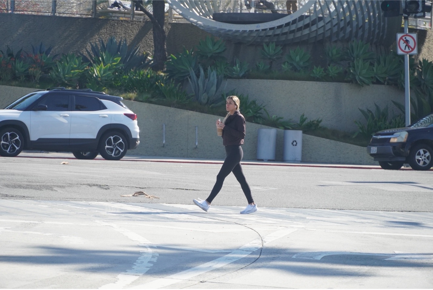 woman walking across a street